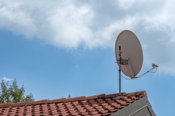 Common causes of satellite dish misalignment including wind damage and loose mounting bolts