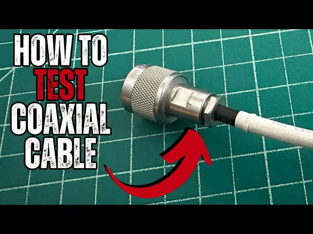 Close-up of coaxial cable connector with multimeter probes testing for a short circuit