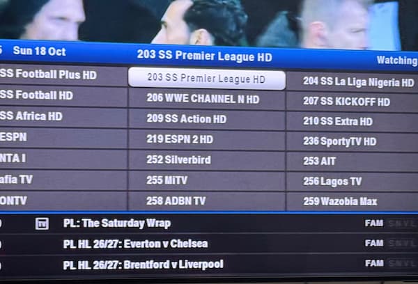 Person using a phone to reset a satellite decoder after channels stopped showing
