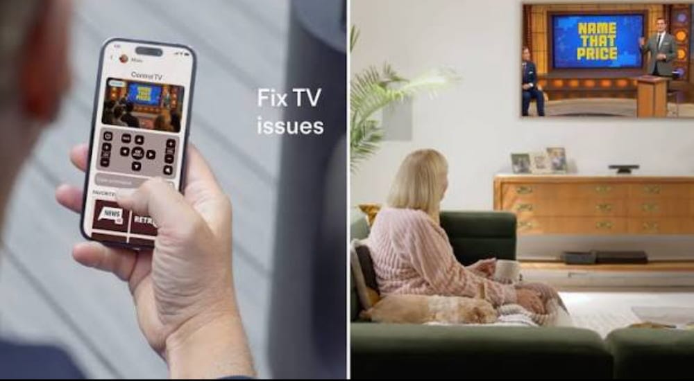 Person holding a smartphone showing a TV control app interface for troubleshooting cable box issues