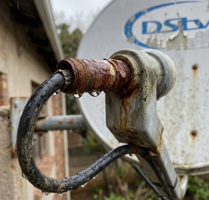 Rusty satellite cable connector beside a clean one, a common cause of DStv no signal.