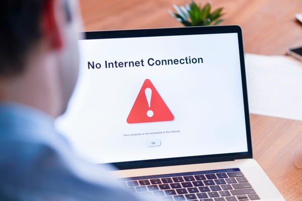 Office workers at desks impacted by internet outage and lost productivity