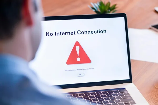 Office workers at desks impacted by internet outage and lost productivity