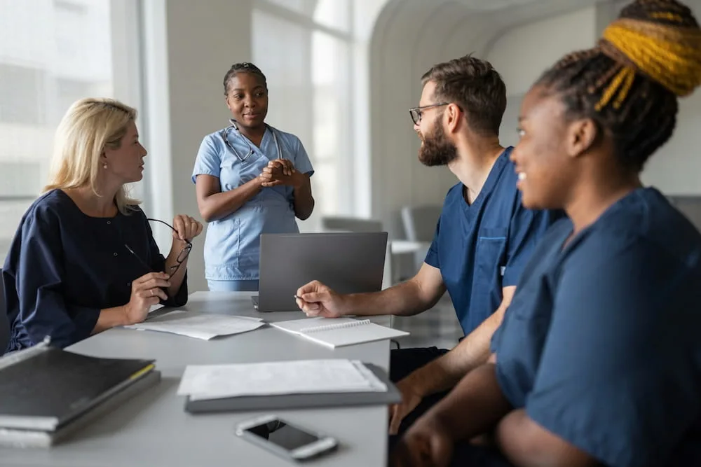 Medical office reception with staff assisting a patient professionally