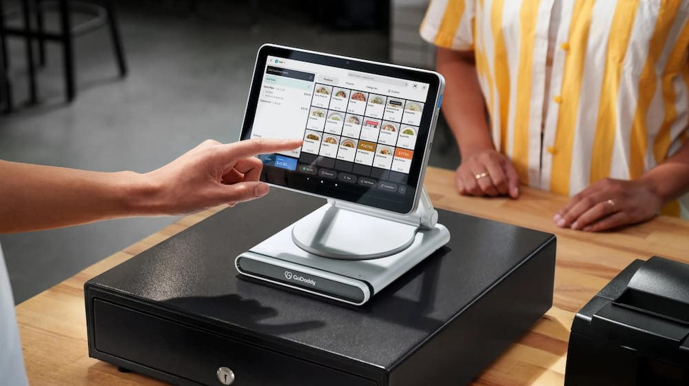 Modern point-of-sale (POS) system on a retail counter with a customer making a payment